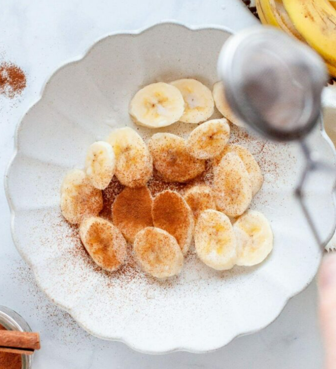 Crispy air fryer banana chips with cinnamon sugar coating on white plate